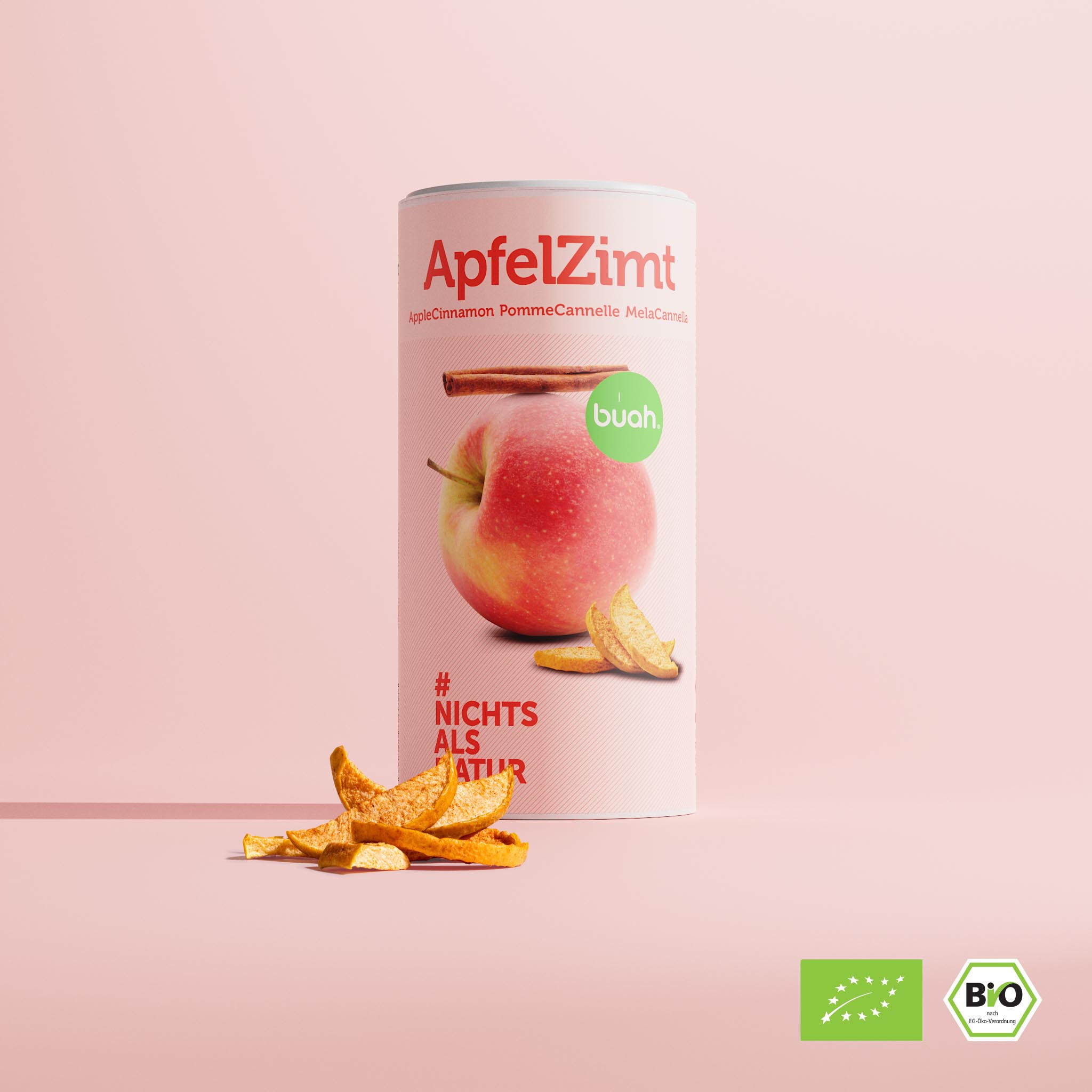 buah groĂźe Dose der neuen Sorte ApfelZimt, zylinder-foermige Dose vor rosa Hintergrund mit dem Abbild eines Apfels und einer Zimtstange, gefriergetrockneter Apfel vor der Dose