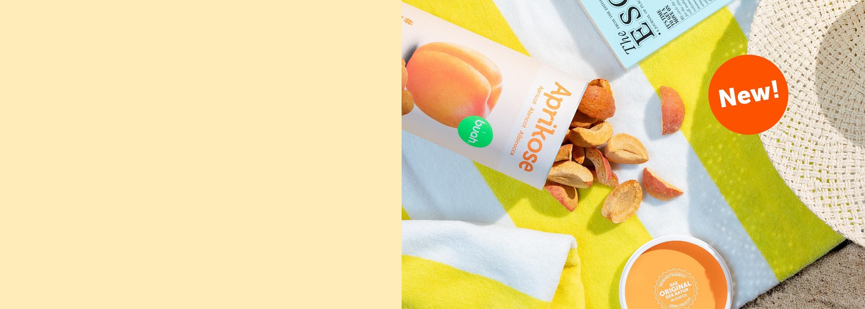Split Screen mit linksseitigem buttergelbem Hintergrund, rechts Bild einer umgekippten buah Dose Aprikose auf einem Strandhandtuch